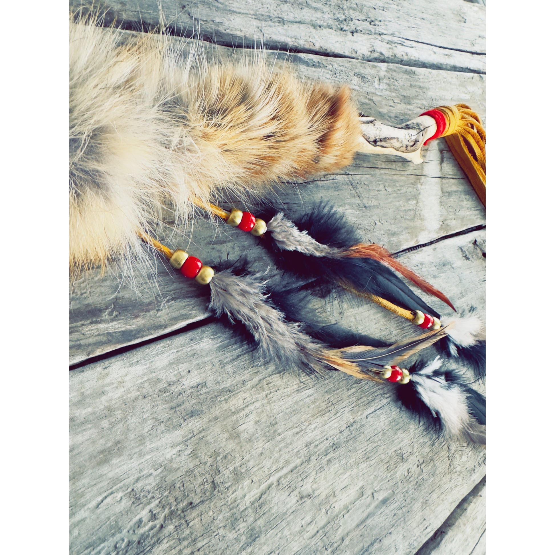 Talking stick with light feathers and mauve details, Indigenous handmade craft
