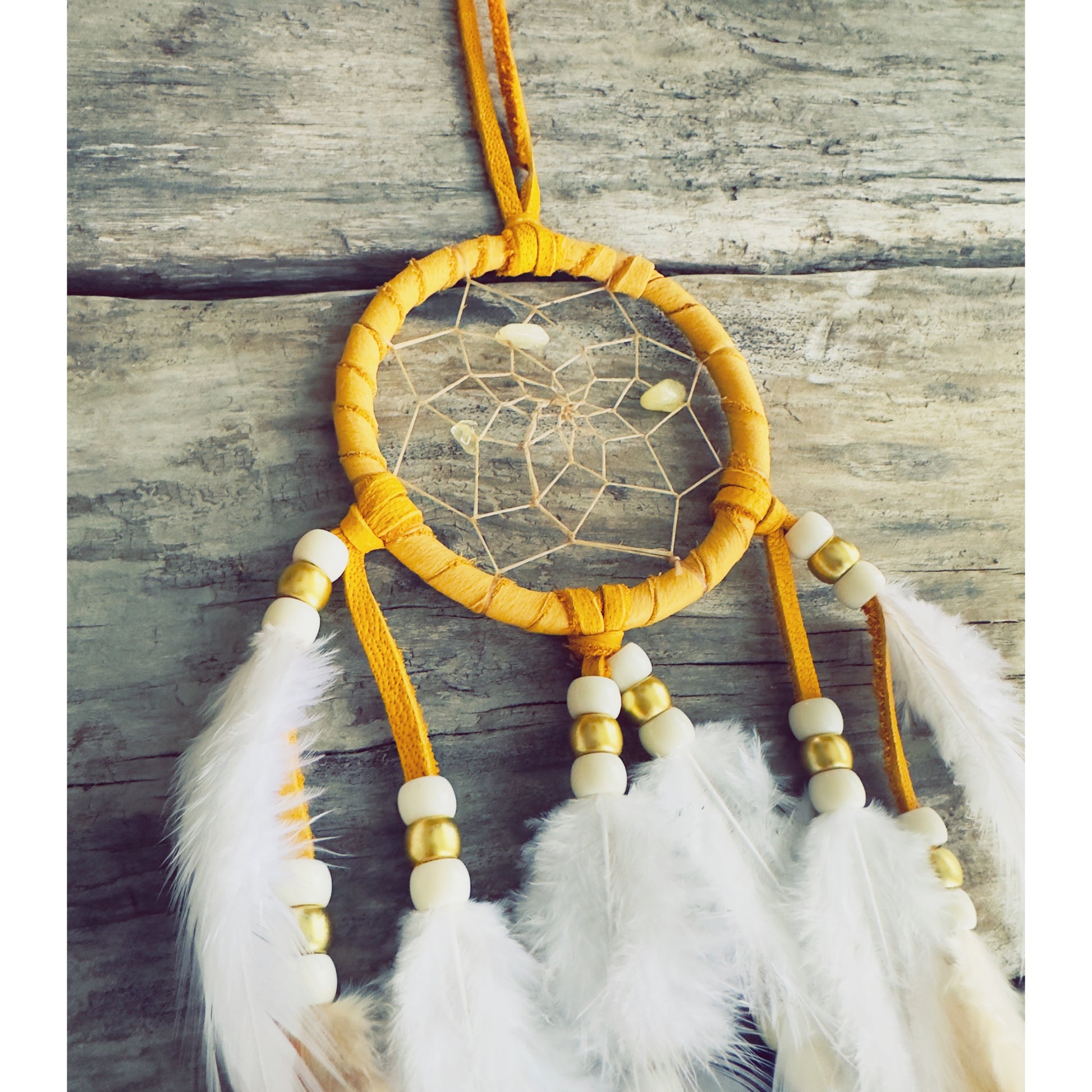 Beige native dreamcatcher with braided hoop and natural feathers