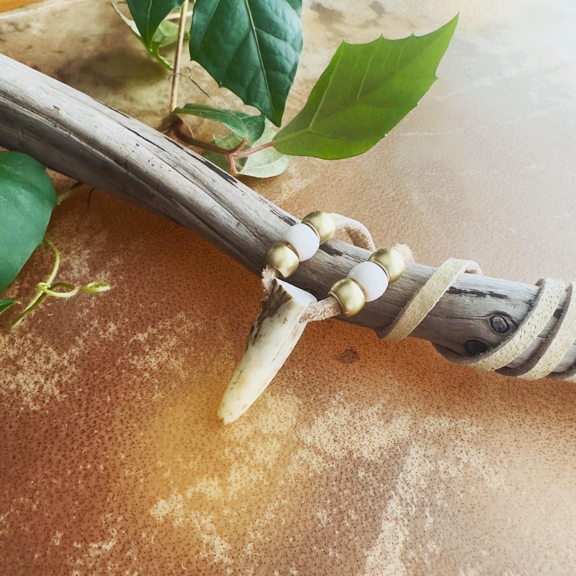 Unique Indigenous necklace made with natural deer antler and moose leather