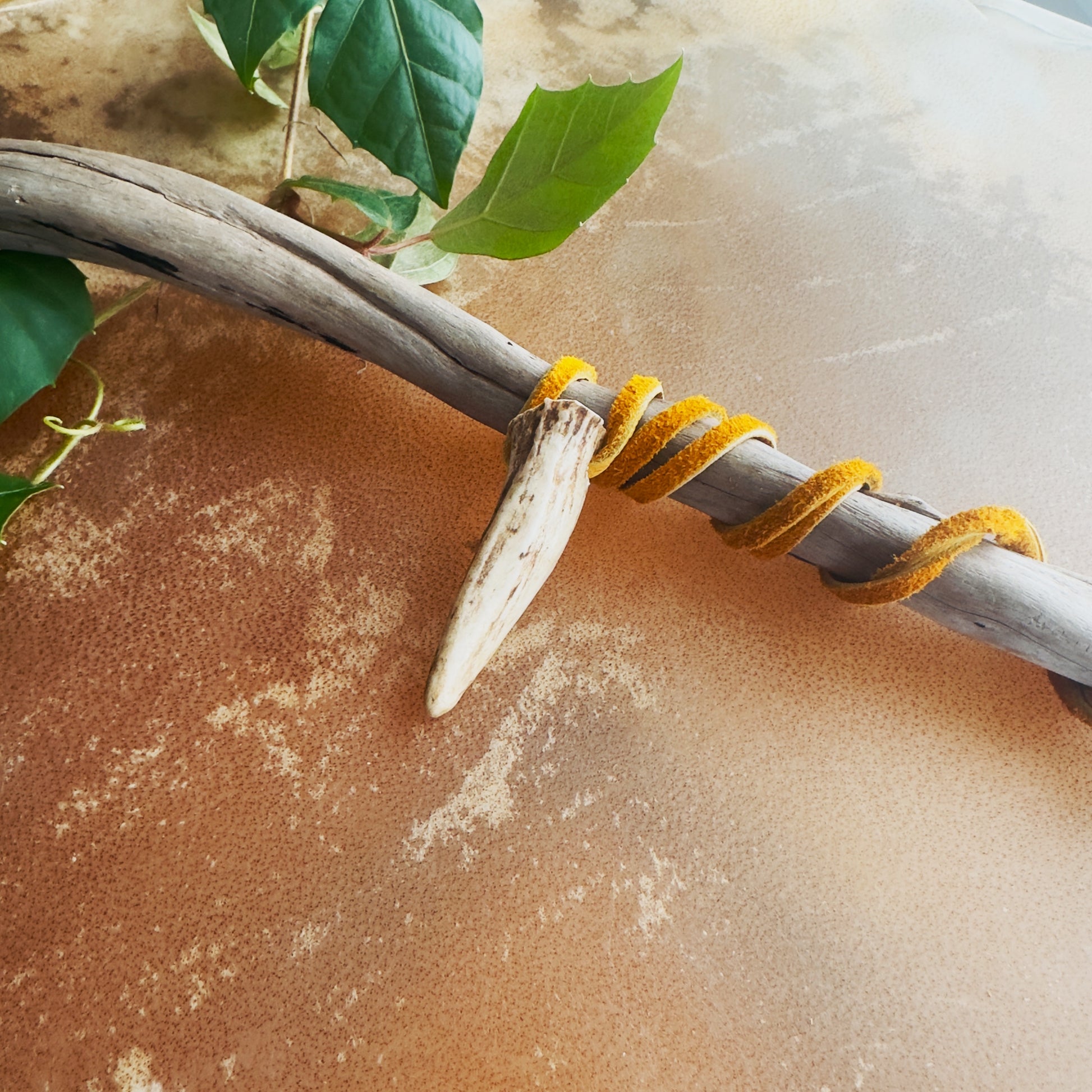 Boreal style Indigenous necklace crafted from natural deer antler and moose leather