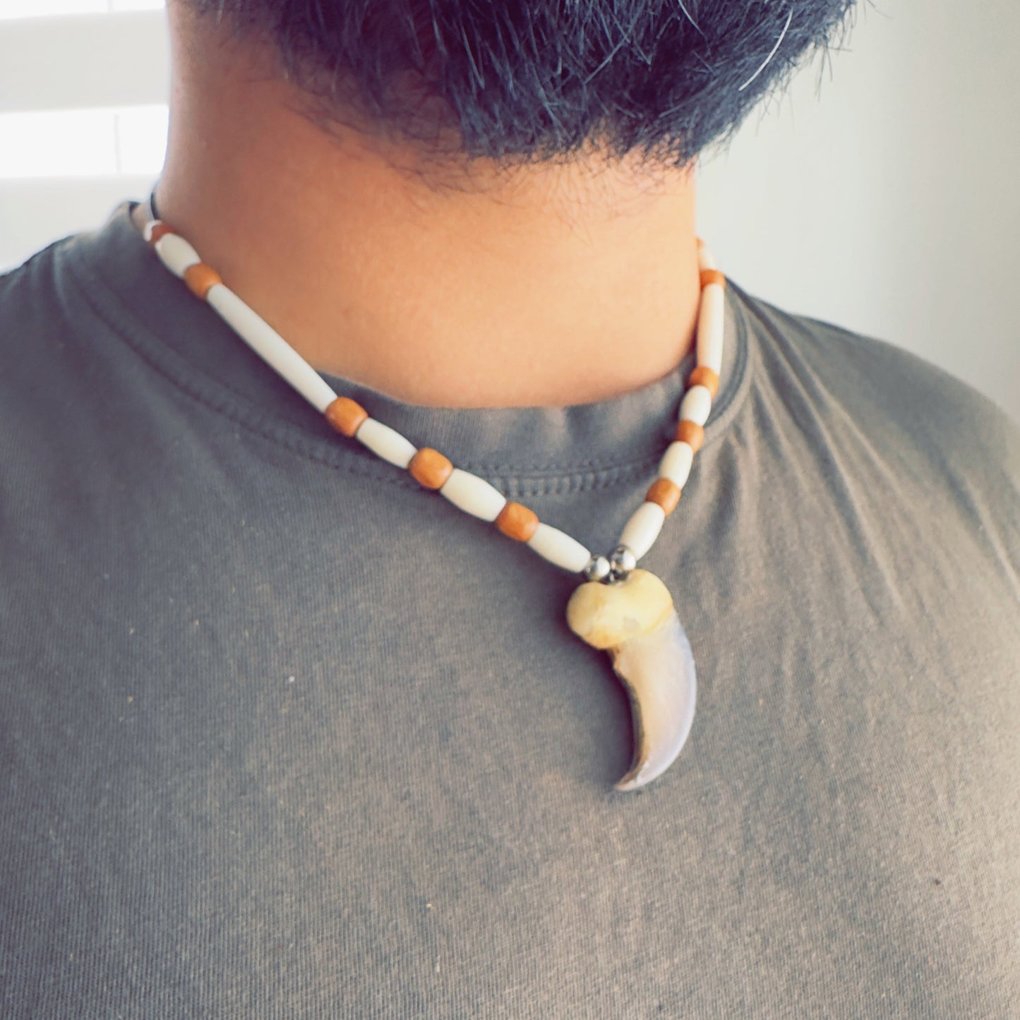 Indigenous handcrafted necklace with bear-inspired pendant and natural tones