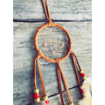 Artisanal dreamcatcher crafted with driftwood and natural stones, symbolic Indigenous-inspired design