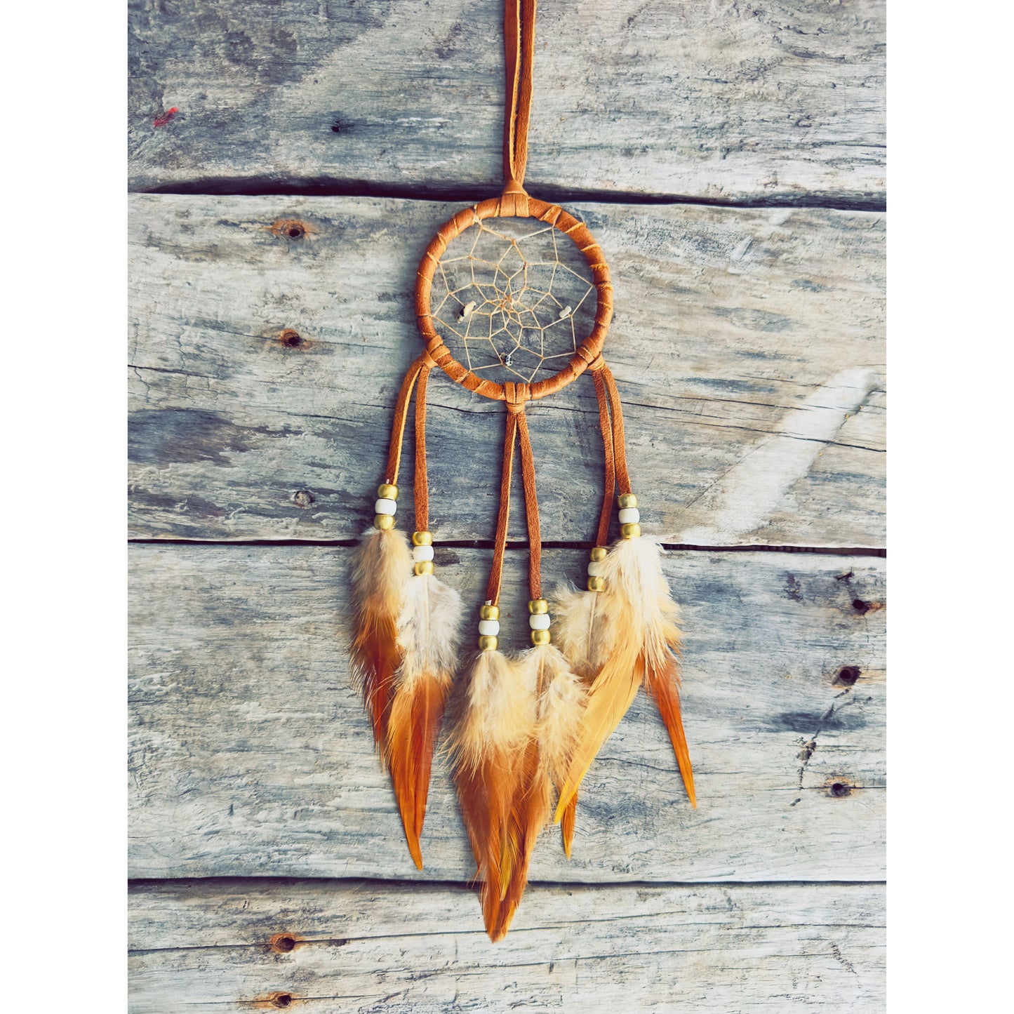 Handmade dreamcatcher with natural feathers and traditional Native craftsmanship.