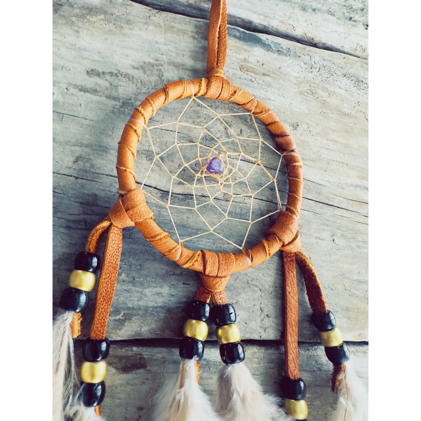 Totem animal dreamcatcher connecting the wearer with spirit guides and animal symbolism in Native spirituality.