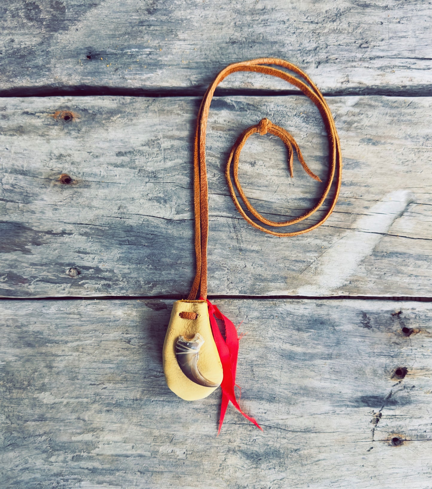 Handmade Indigenous medicine pouch in genuine moose leather with red ribbon accent