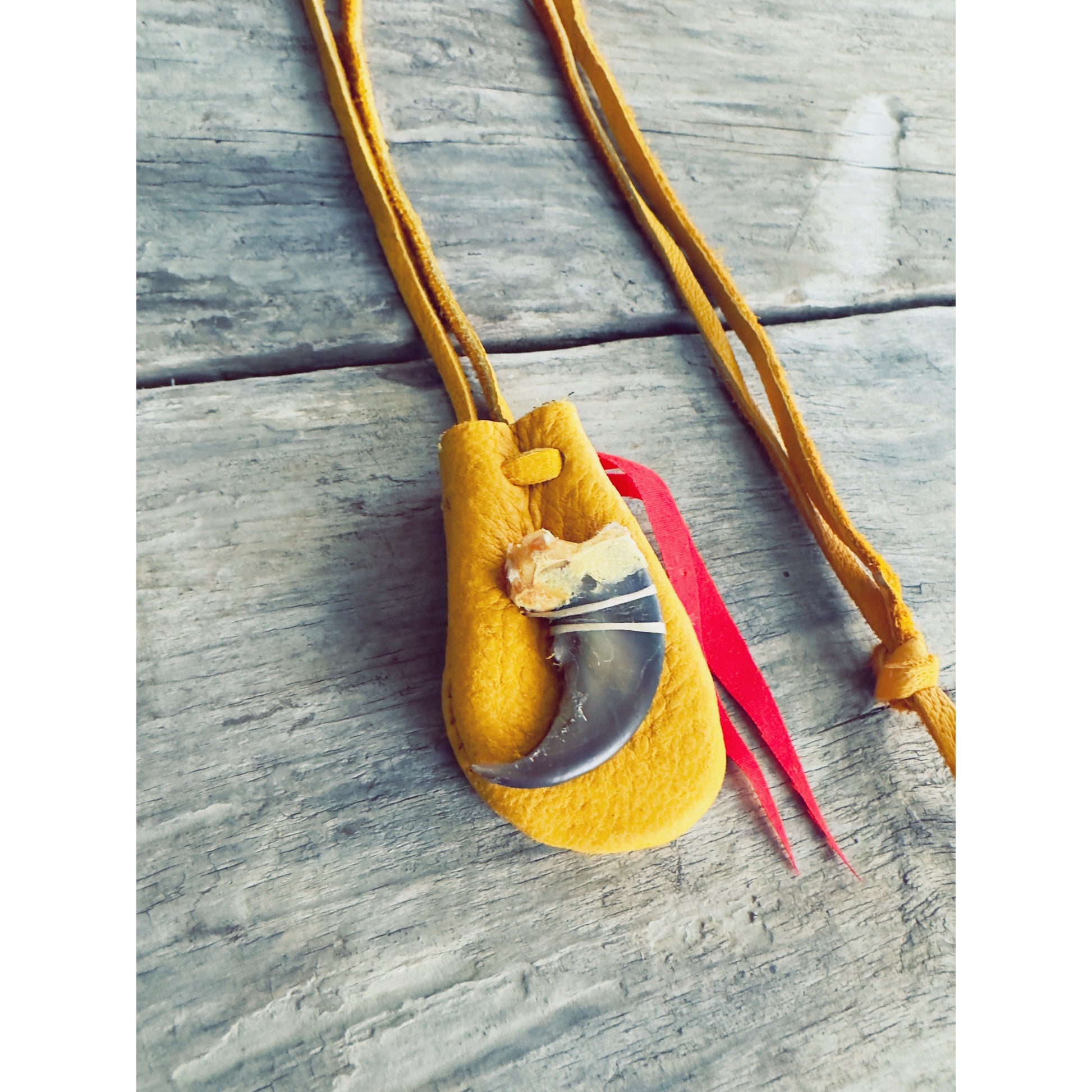 Small Indigenous medicine pouch with animal claw detail and leather cord